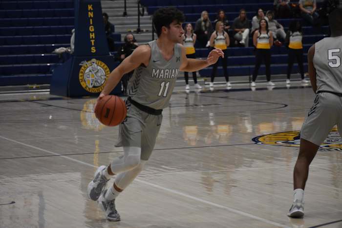 Luke Heady scans the floor during a game at Marian.